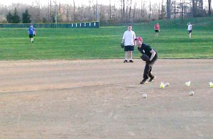Manager Ron Brown pitching  batting practice.