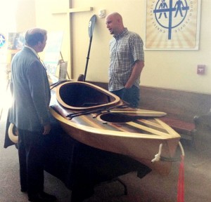Urban Promise's Jeff VanderKuip with a Kayak built by Urban Promise students.